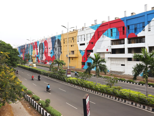a city street with a mural on the side of a building