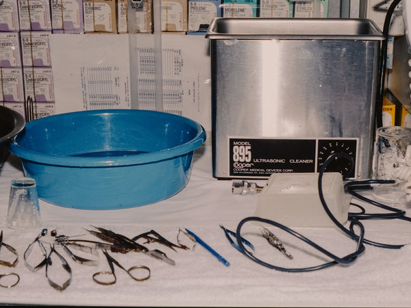 Surgical instruments and cleaning equipment on a table.